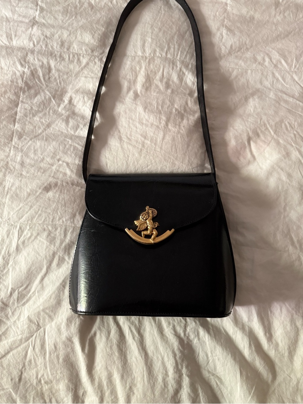 Classic Black Shoulder Bag with Gold Emblem Accent